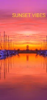 Vibrant sunset over a harbor with boats and reflections.