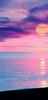 Vibrant sunset over ocean with pink and purple sky reflections.