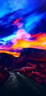 Vibrant sunset over a mountain path with vivid hues and a dark blue sky.