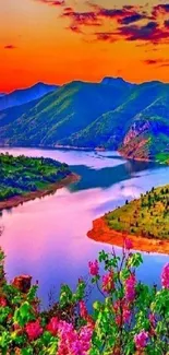 Vibrant sunset over mountains with colorful sky and river view.