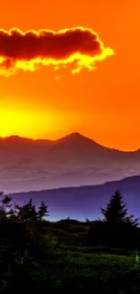 Stunning vibrant sunset over silhouetted mountains.