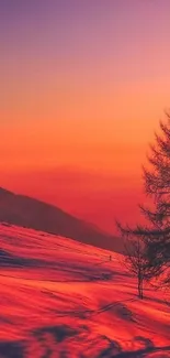 Vibrant sunset over snow-covered mountains with a striking orange and purple sky.