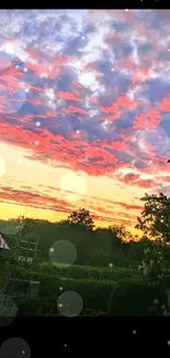 Stunning sunset with pink clouds over countryside landscape.