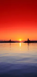 Vibrant sunset over ocean creating a calming red and blue ambiance.