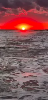 Vibrant sunset over ocean with red sky and waves