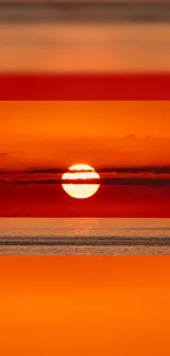 A vibrant orange sunset over a calm ocean, casting a serene glow.