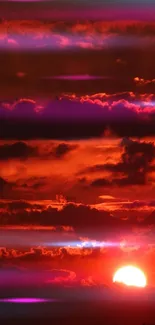 Vibrant sunset with red sky and clouds.