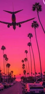 Plane flying at sunset over palm trees with a vivid pink sky.