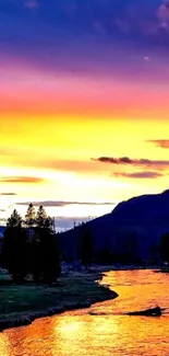 Serene river under vibrant sunset sky with silhouetted trees.