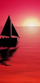 Silhouetted sailboat on vibrant red sunset waters.