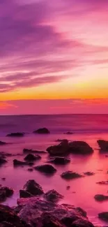 Vibrant sunset seascape with colorful skies and rocky shoreline.