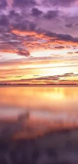 Vibrant purple and orange sunset reflected on a tranquil water surface.