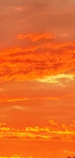 Vibrant orange sunset sky with dramatic clouds for mobile wallpaper.