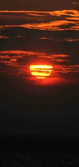 Vibrant sunset with orange sky over the ocean.