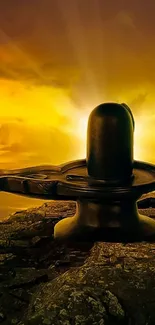 Shiv Ling silhouetted against a vibrant golden sunset.