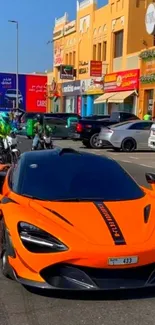 Orange supercar on a busy city street with bikes and cars.