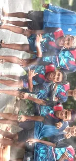 Cheerful group of young athletes posing outdoors in colorful attire.