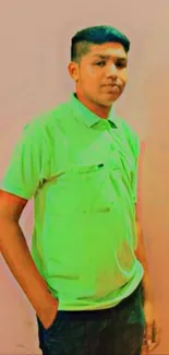 Teen in green shirt with pink background.