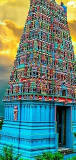 Intricate temple tower with vibrant colors under dramatic sky.