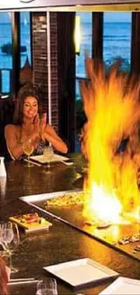 Teppanyaki chef cooks with flames while guests watch.