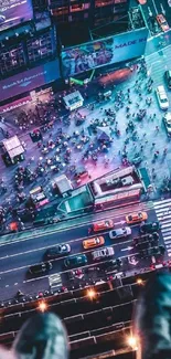 Aerial view of Times Square bustling with people and glowing city lights.