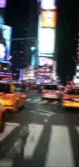 Dynamic Times Square at night with bright lights and yellow taxis.