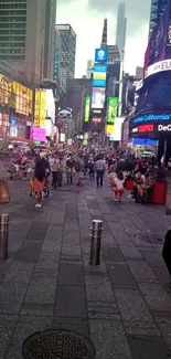 Vibrant Times Square evening scene with colorful lights and bustling crowd.