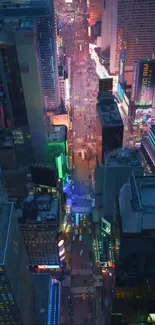 Aerial view of Times Square with vibrant night lights and tall skyscrapers.