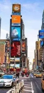 Colorful Times Square street view with taxis and billboards in New York City.