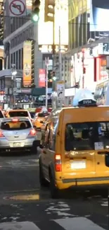 Busy Times Square street with yellow taxis and city lights.