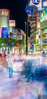 Vibrant night scene at Tokyo's Shibuya Crossing.