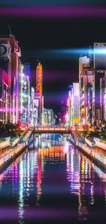 Vibrant Tokyo canal with colorful city lights reflecting in the water at night.