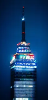 Night view of a tall city tower with vibrant neon lights.