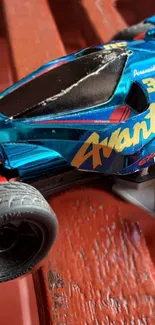 Close-up of a colorful toy race car on a textured surface.