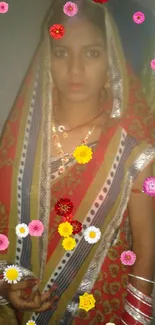 Woman in traditional vibrant red saree with intricate patterns and colorful accents.