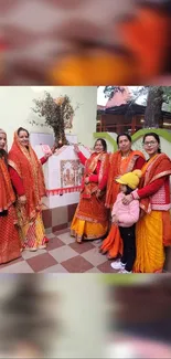 Women in vibrant traditional attire with orange and yellow colors.