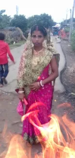 Woman in vibrant traditional attire on rural road.