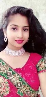 Woman in vibrant traditional attire with intricate embroidery.