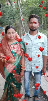 Traditional couple posing in nature with vibrant attire.