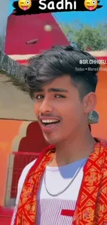 Young man in colorful traditional attire with a vibrant background.