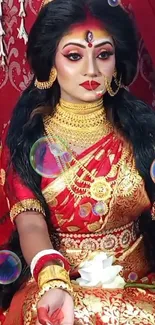 Vibrant traditional portrait with red attire and gold jewelry.