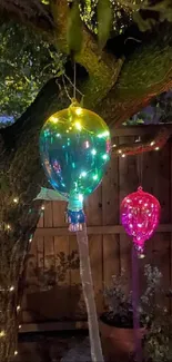 Colorful glowing lights hanging in a tree, creating a vibrant outdoor display.