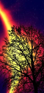 Tree silhouette with cosmic colorful sky backdrop.