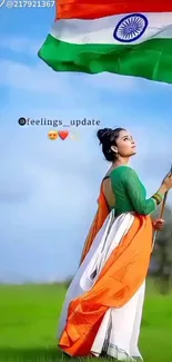 Woman holding Indian flag under blue sky.