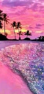 Tropical sunset with pink sky and palm trees on the beach.