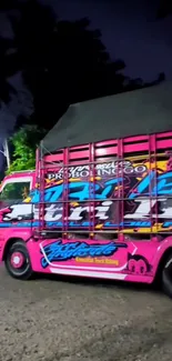 Colorful truck with graffiti art on a vibrant pink background.