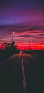 Mobile wallpaper featuring a vibrant twilight road under a colorful purple sky.