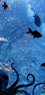 Underwater ocean scene with fish silhouette and coral reef.