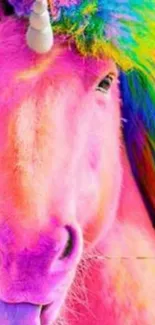 Colorful unicorn wallpaper with pink hues and a rainbow mane.