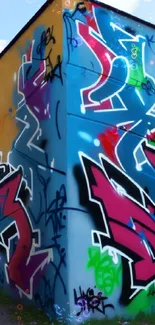 Colorful graffiti art on a blue wall with urban style and vibrant design.